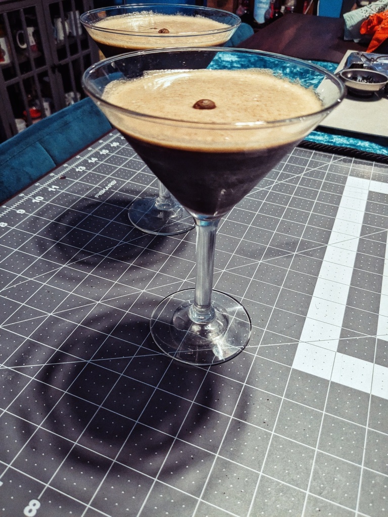 two espresso martinis sitting on a table